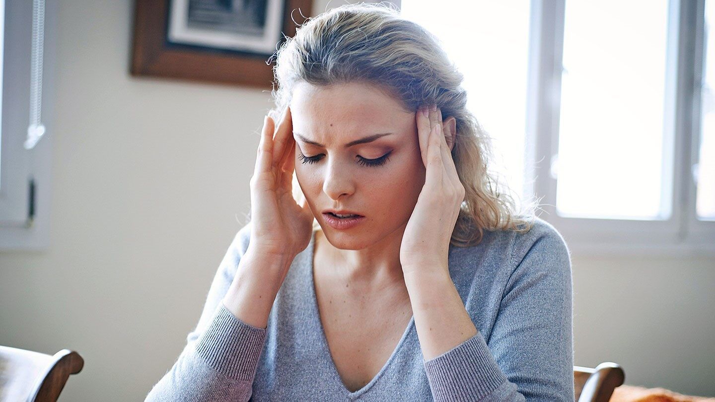 a woman holding her temples